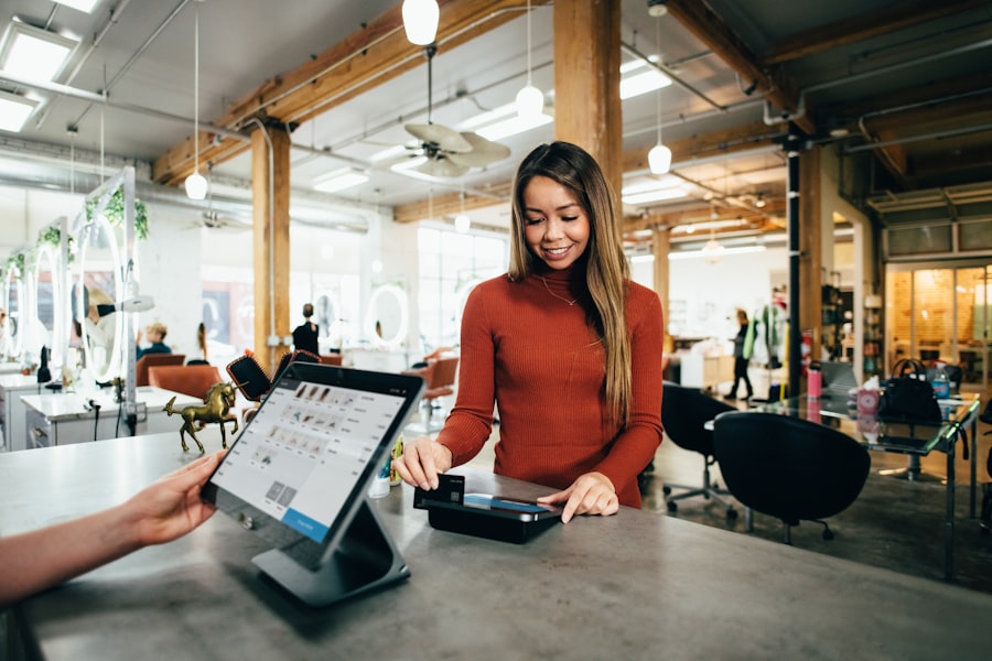 Owner taking a payment at a salon counter
